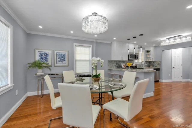 a dining room with furniture and a chandelier