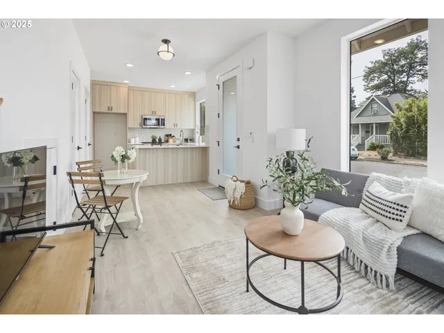 a living room with furniture and a dining table with kitchen view
