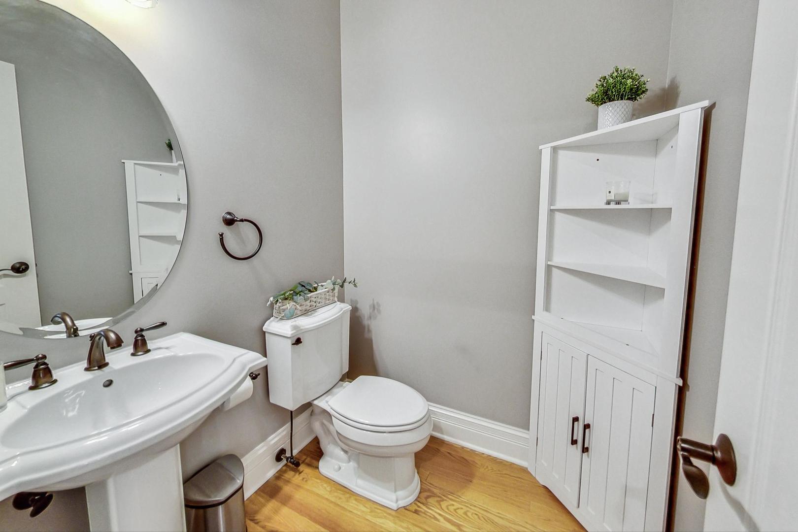 1450 East Northwest Highway, Unit 13 Arlington Heights, IL 60004 - Photo 13 of 33 a bathroom with a sink a toilet and a mirror
