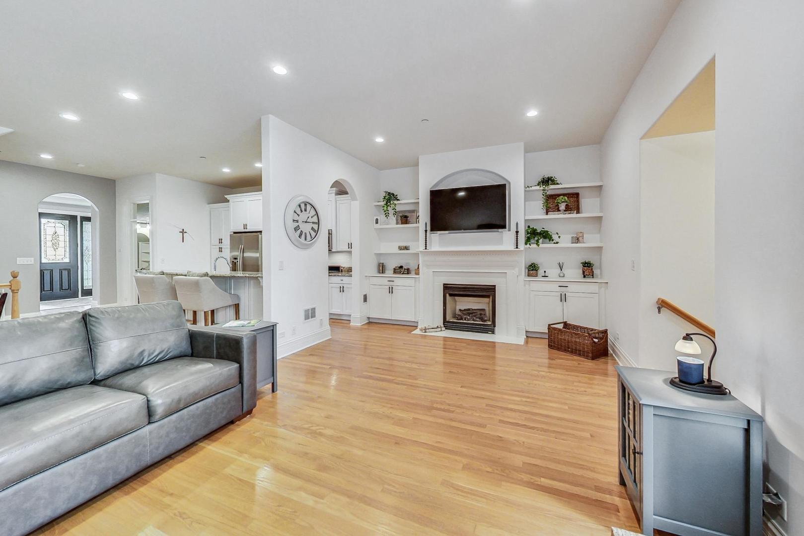 1450 East Northwest Highway, Unit 13 Arlington Heights, IL 60004 - Photo 14 of 33 a living room with furniture a fireplace and a flat screen tv