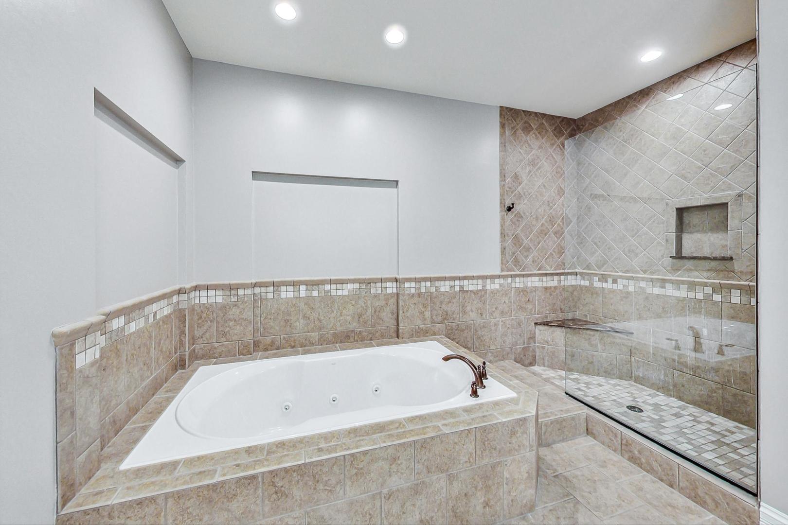 1450 East Northwest Highway, Unit 13 Arlington Heights, IL 60004 - Photo 23 of 33 a bathroom with a bathtub and shower