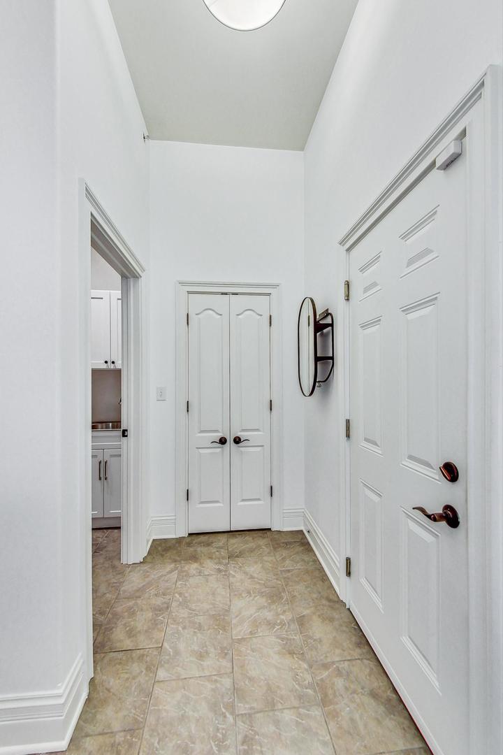 1450 East Northwest Highway, Unit 13 Arlington Heights, IL 60004 - Photo 27 of 33 a view of a livingroom with wooden floor and cabinet