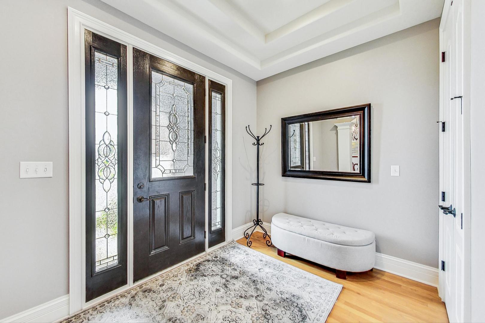 1450 East Northwest Highway, Unit 13 Arlington Heights, IL 60004 - Photo 4 of 33 a bedroom with a bed and wooden floor