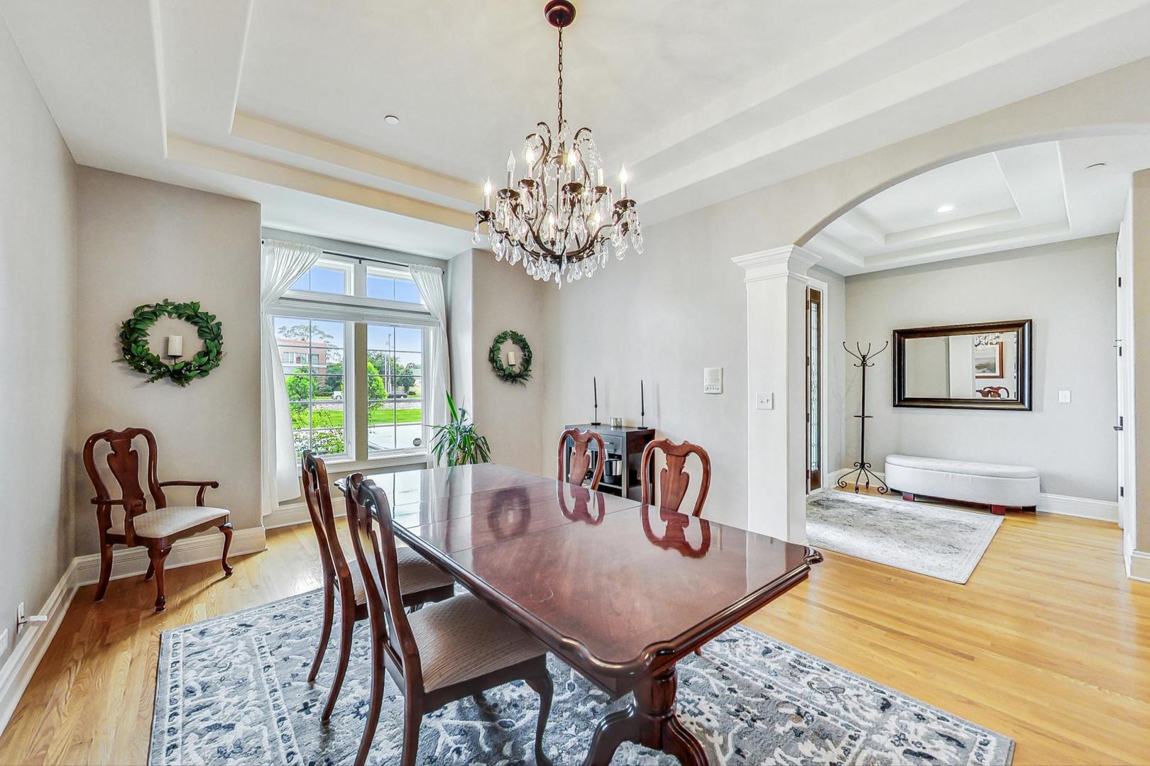 1450 East Northwest Highway, Unit 13 Arlington Heights, IL 60004 - Photo 5 of 33 a view of a dining room with furniture and a chandelier