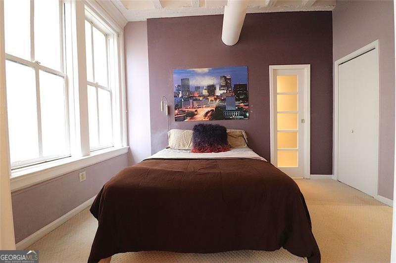 32 Peachtree Street, Unit 1601 Atlanta, GA 30303 - Photo 18 of 55 a bedroom with a bed and a window