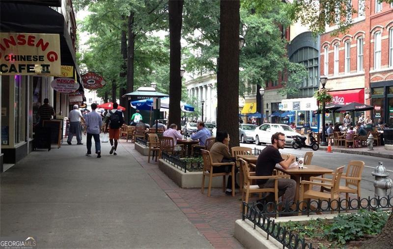 32 Peachtree Street, Unit 1601 Atlanta, GA 30303 - Photo 45 of 55 a couple of people sitting in a yard in front of retail shops
