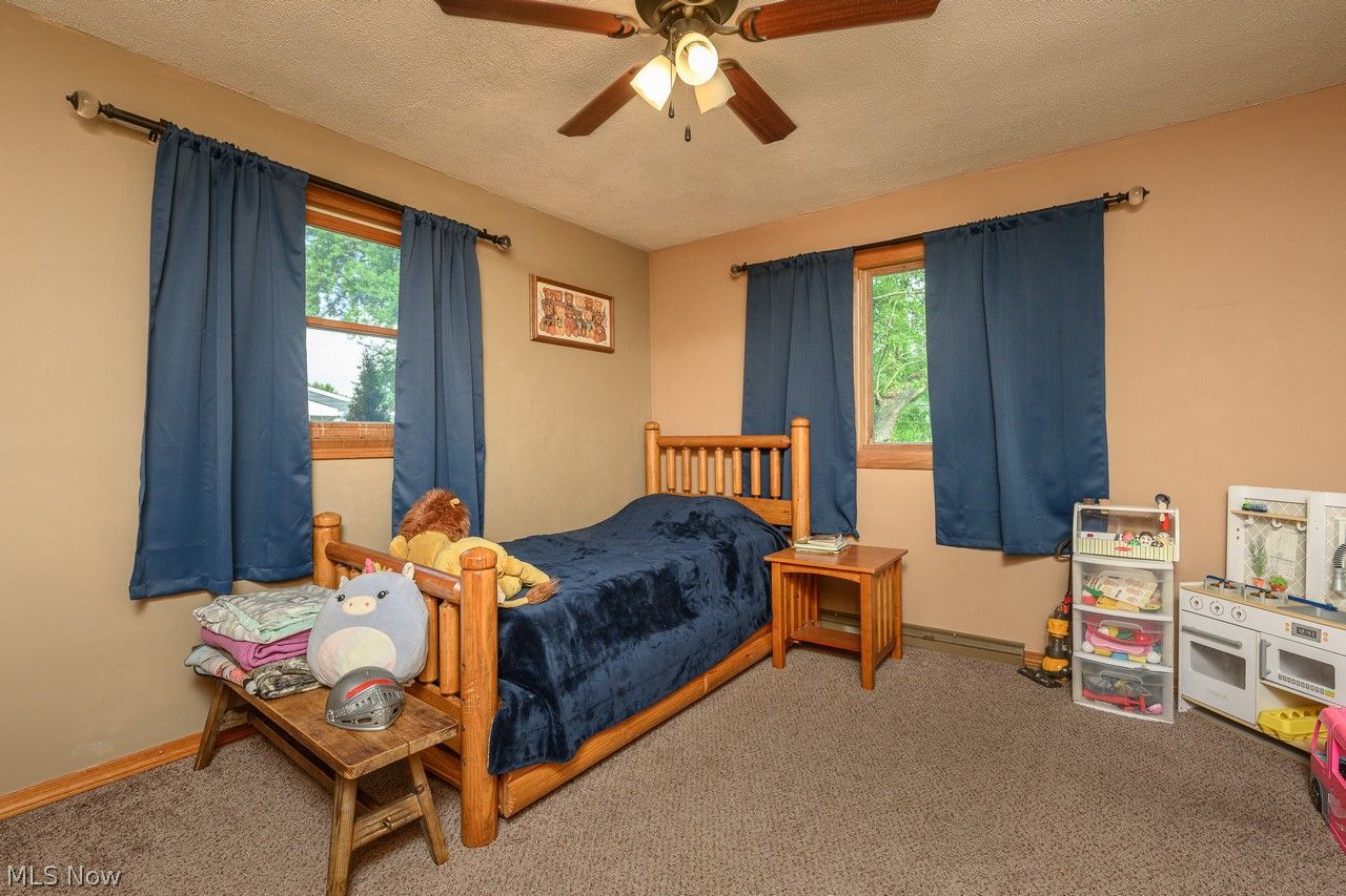 3912 Rolling Ridge Road Northeast Canton, OH 44721 - Photo 13 of 33 Bedroom with multiple windows, ceiling fan and carpet flooring