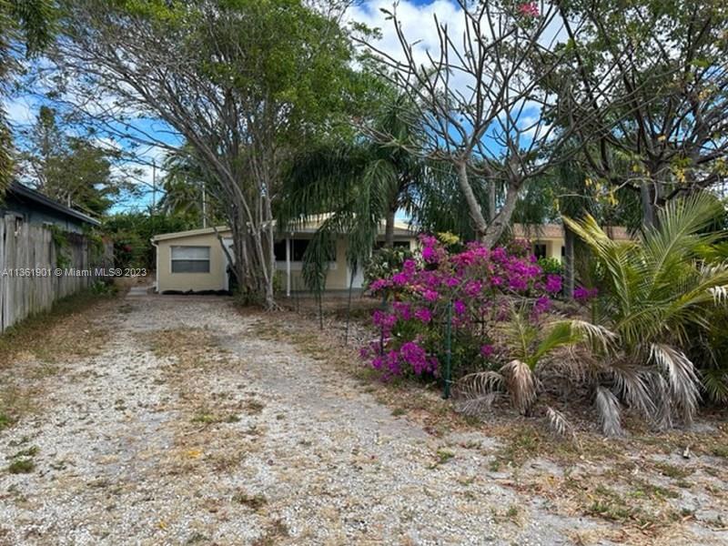 363 Glouchester Street Boca Raton, FL 33487 - Photo 2 of 13 a view of a backyard with a garden and trees