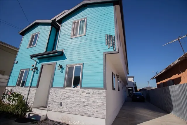 a large kitchen with stainless steel appliances kitchen island granite countertop wooden cabinets a sink and dishwasher