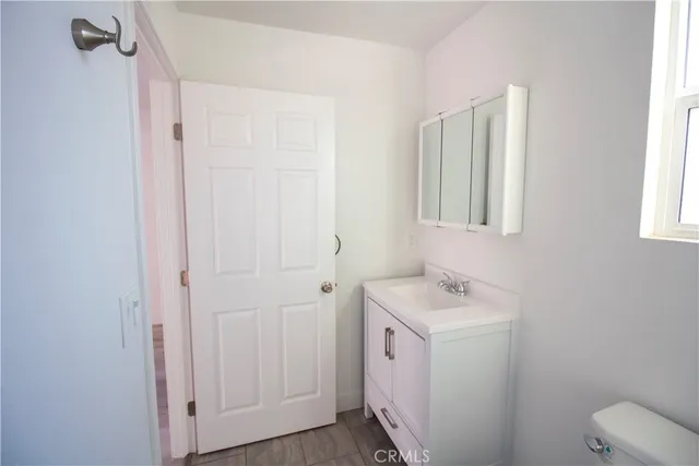 a bathroom with a sink toilet and vanity