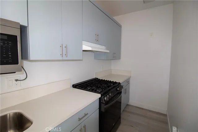 a kitchen with a stove and cabinets