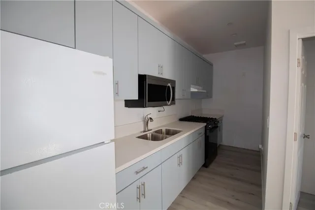 a kitchen with a sink and a microwave