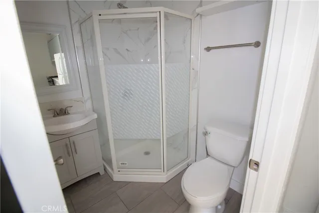 a view of a livingroom with wooden floor and a window