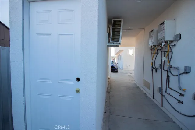 an empty room with windows and cabinet