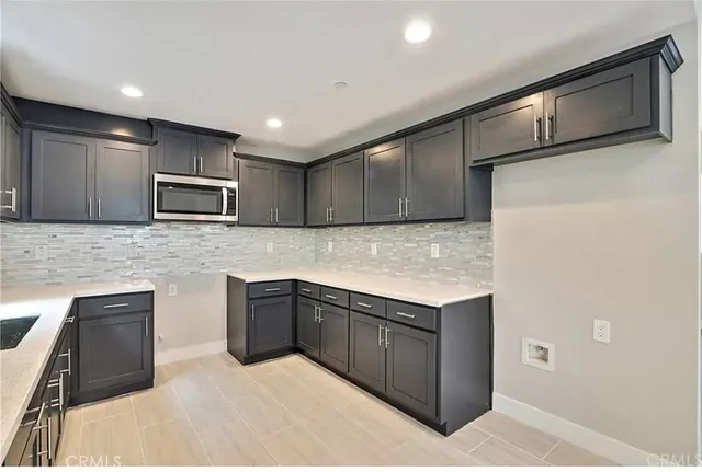 a view of a kitchen with a sink and a dishwasher