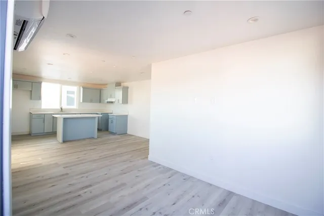 a view of a kitchen with wooden floor and a sink