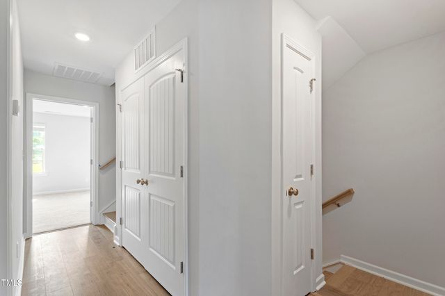 a view of a hallway with wooden floor