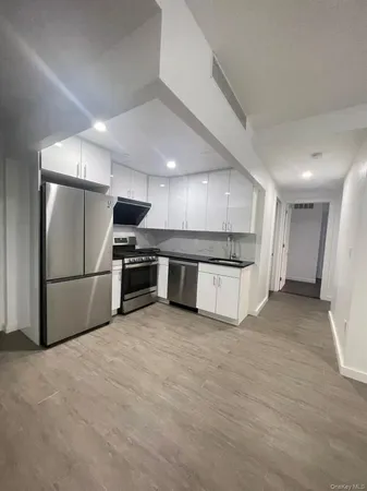 a kitchen with stainless steel appliances a refrigerator and a stove top oven