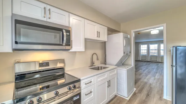 a kitchen with stainless steel appliances granite countertop a stove microwave and refrigerator