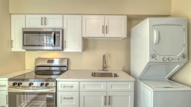 a kitchen with cabinets and a stove top oven