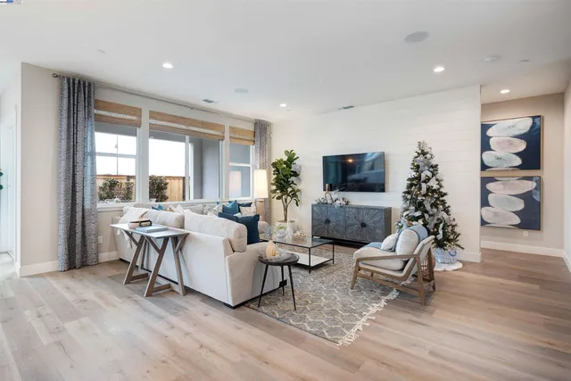 a living room with furniture large window and flat screen tv
