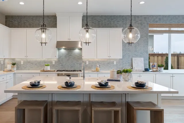 a kitchen that has a lot of cabinets in it and wooden floors