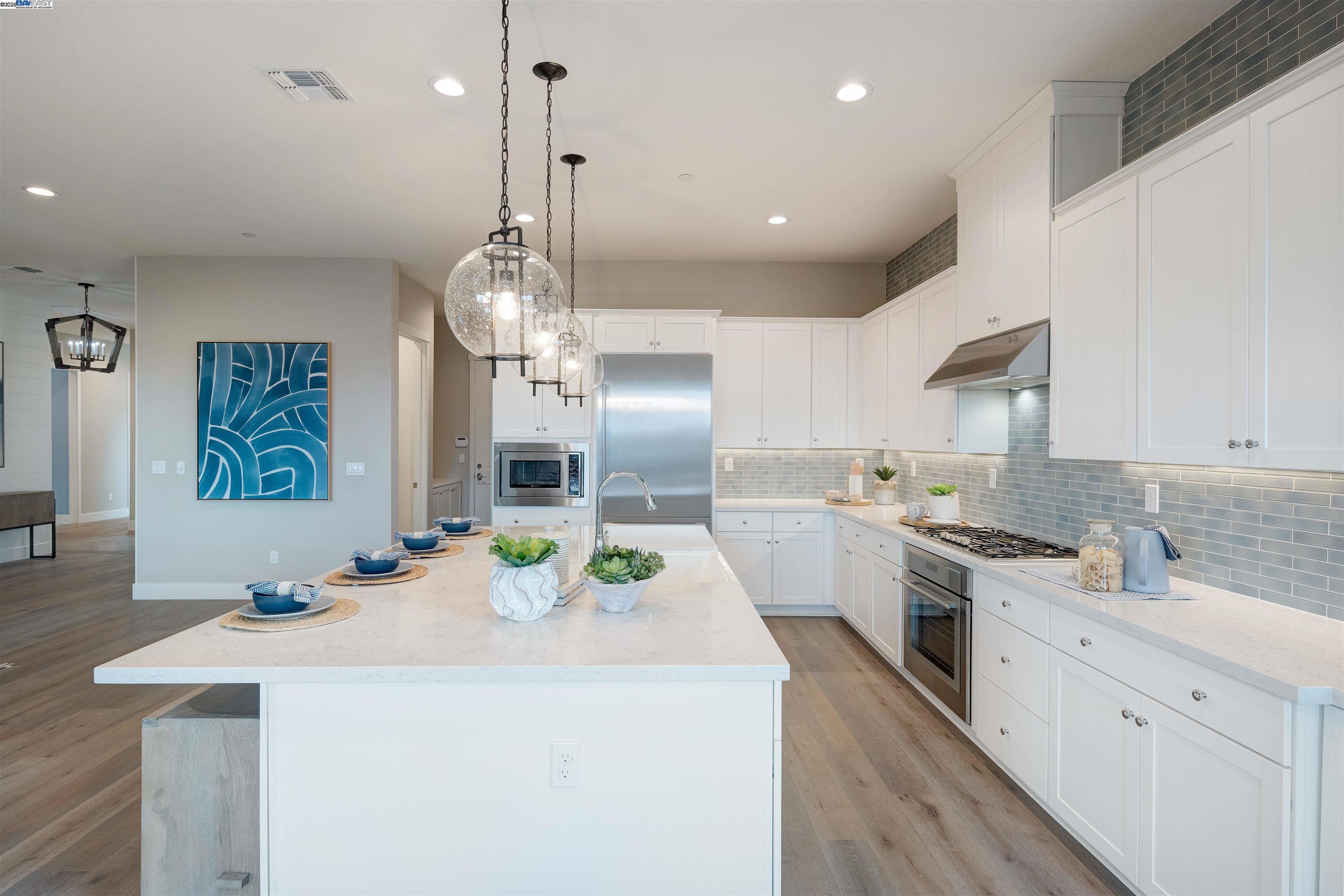 1371 Crescent Avenue Manteca, CA 95336 - Photo 18 of 55 a kitchen that has a lot of cabinets in it and wooden floors