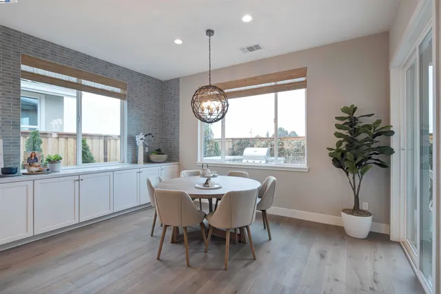 a kitchen with a dining table and chairs