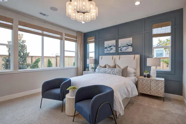 a bedroom with a large bed and a window