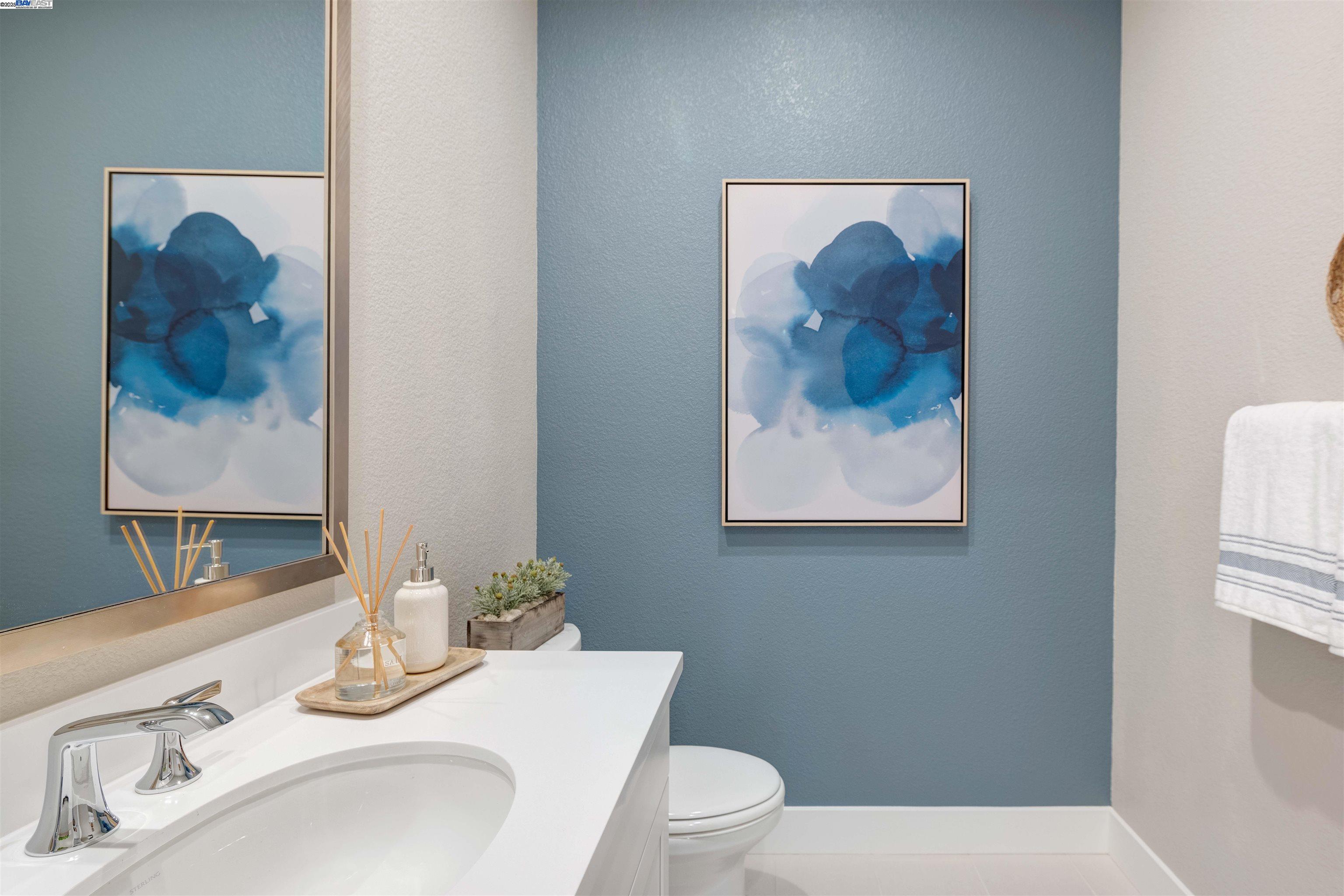 1371 Crescent Avenue Manteca, CA 95336 - Photo 37 of 55 a bathroom with a toilet a sink and mirror