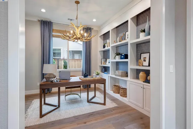 a bedroom with a bed and dresser with mirror