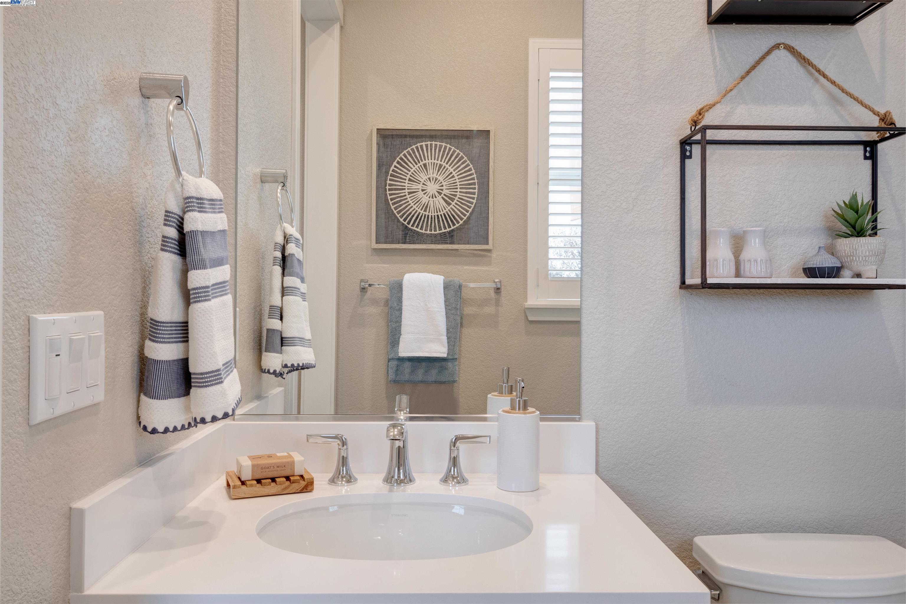 1371 Crescent Avenue Manteca, CA 95336 - Photo 48 of 55 a bathroom with a toilet a sink and mirror