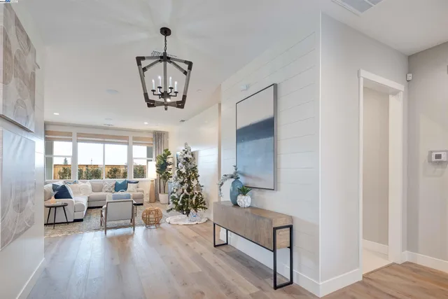 a living room with furniture and a chandelier
