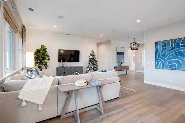 a living room with furniture and kitchen view