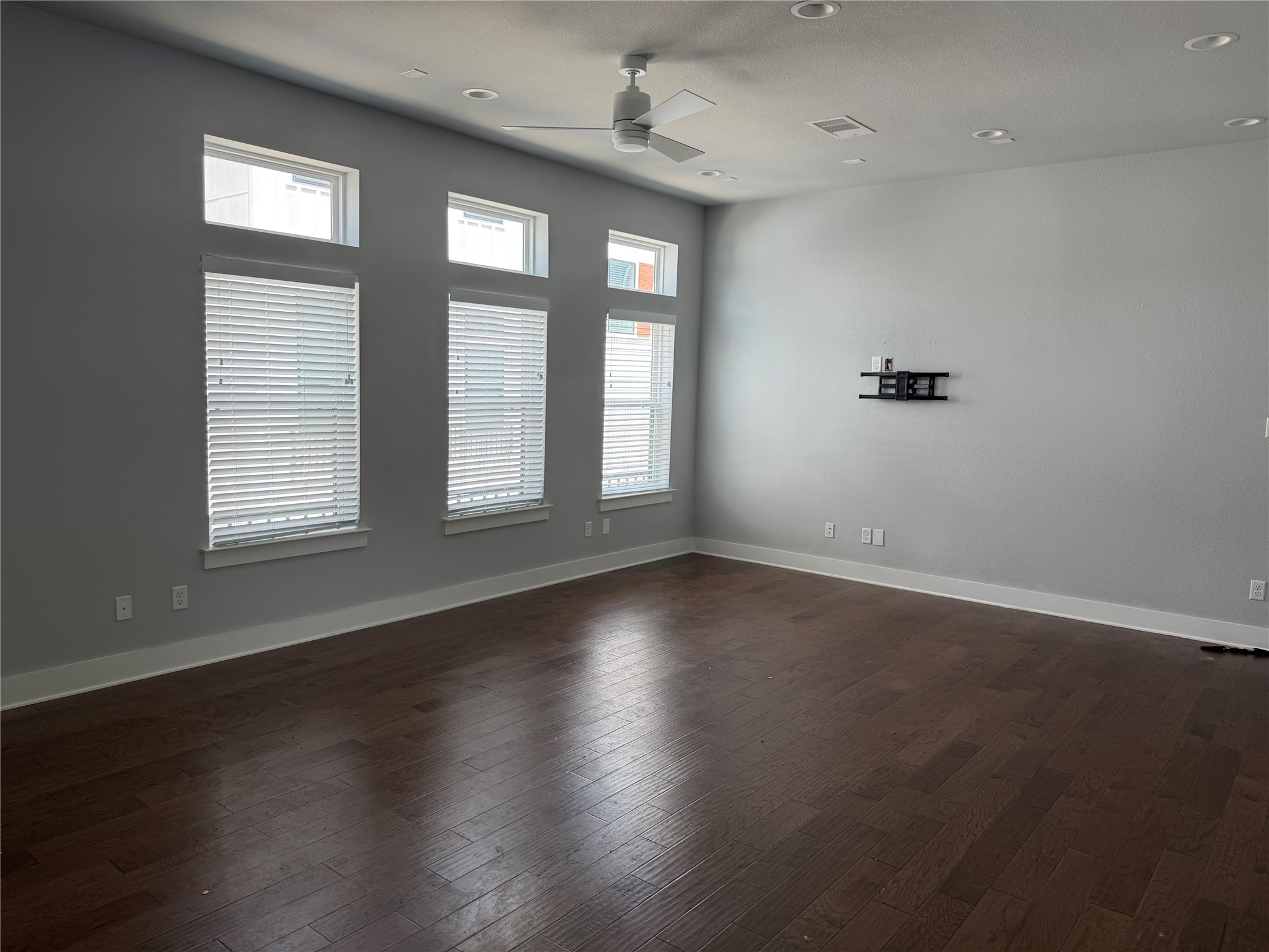 902 Martin Street, Unit A Houston, TX 77018 - Photo 3 of 21 an empty room with wooden floor and windows