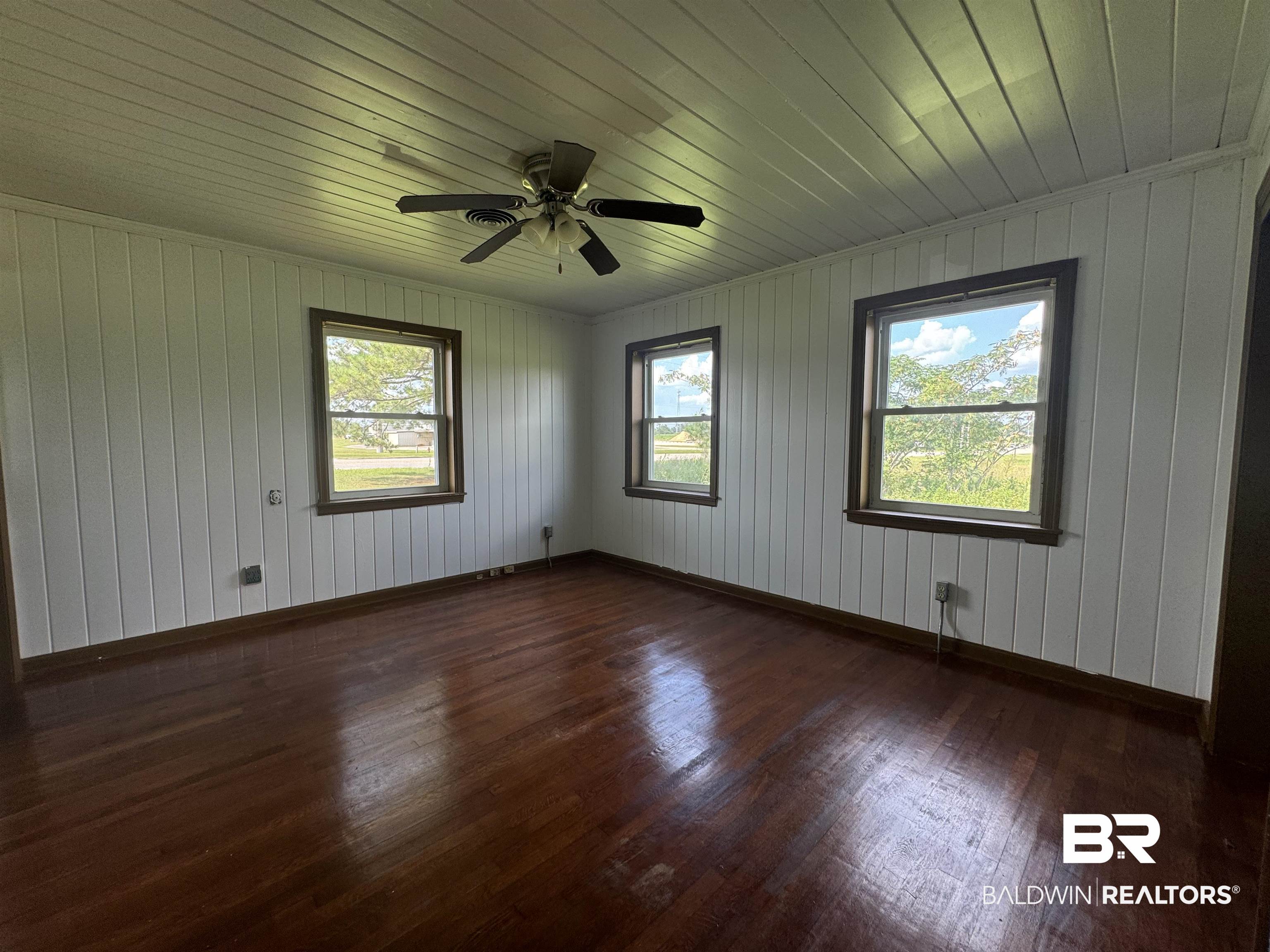 22720 Highway 31 Flomaton, AL 36441 - Photo 20 of 22 Spare room with wood ceiling, wood walls, dark wood-type flooring, and ceiling fan