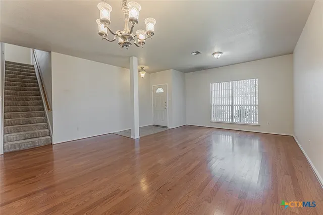 a large kitchen with kitchen island granite countertop lots of white cabinets a sink and dishwasher