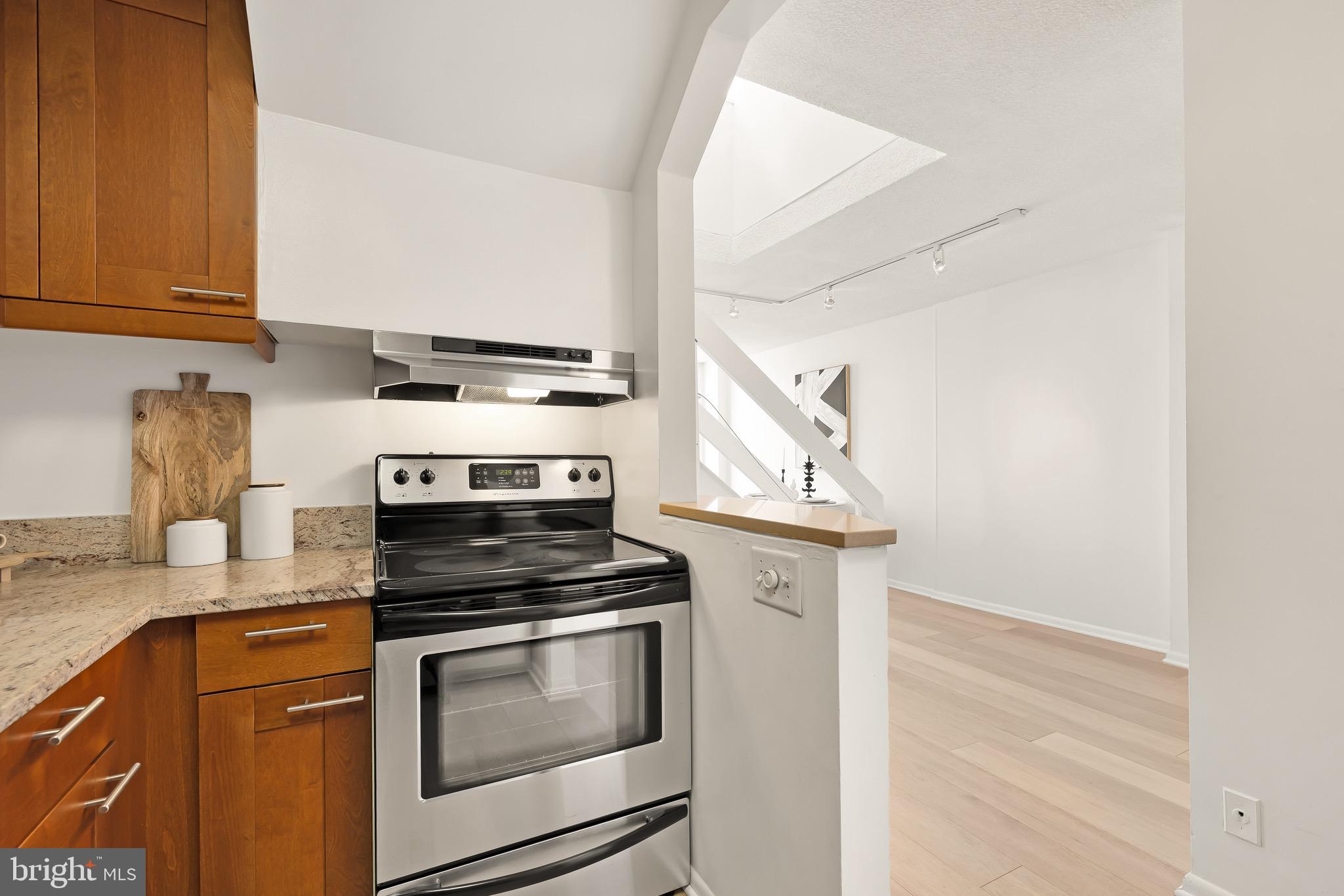 1800 R Street Northwest, Unit 807 Washington, DC 20009 - Photo 12 of 23 a kitchen with granite countertop a stove and a sink