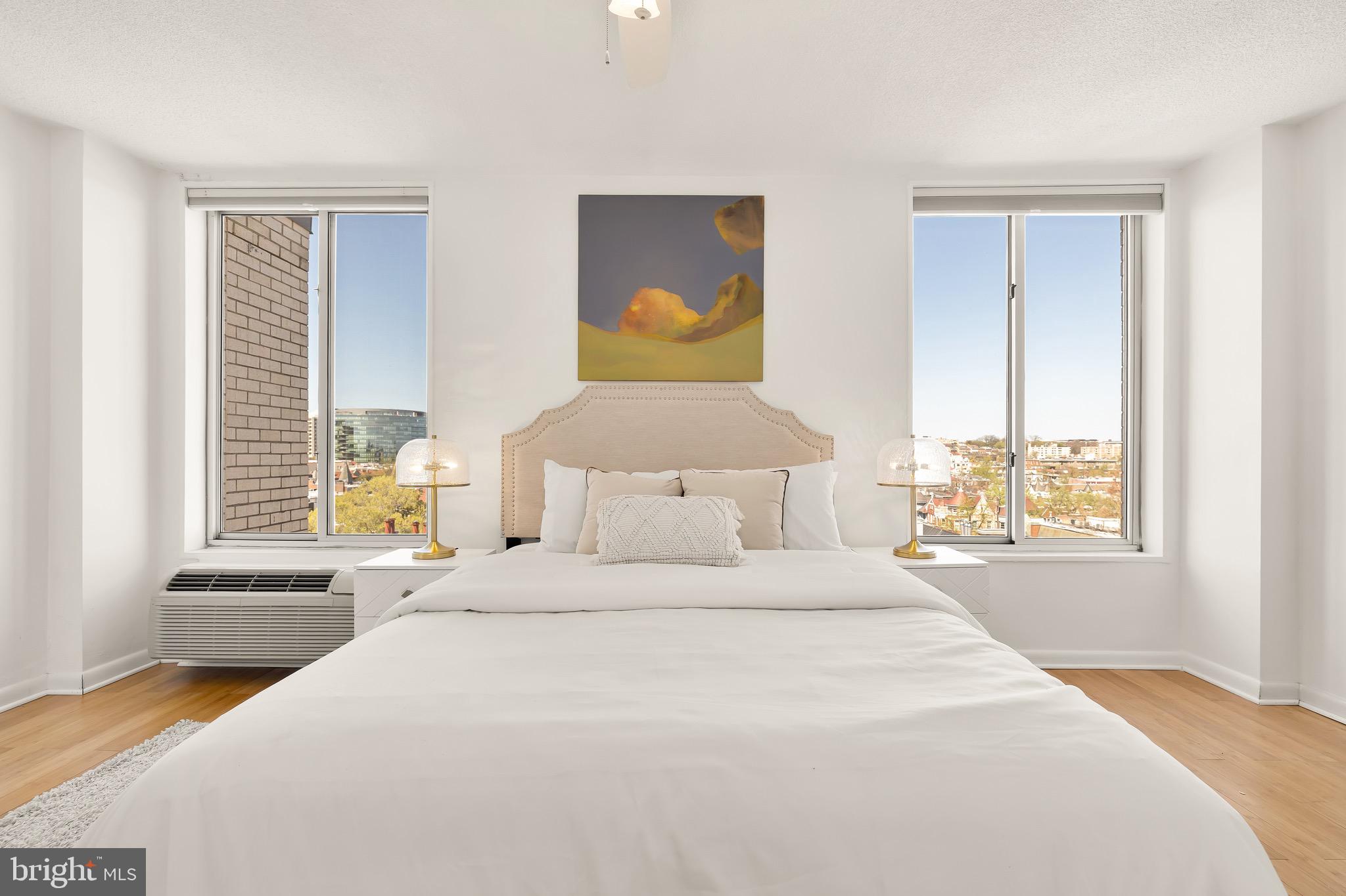1800 R Street Northwest, Unit 807 Washington, DC 20009 - Photo 19 of 23 a bedroom with a bed and wooden floor