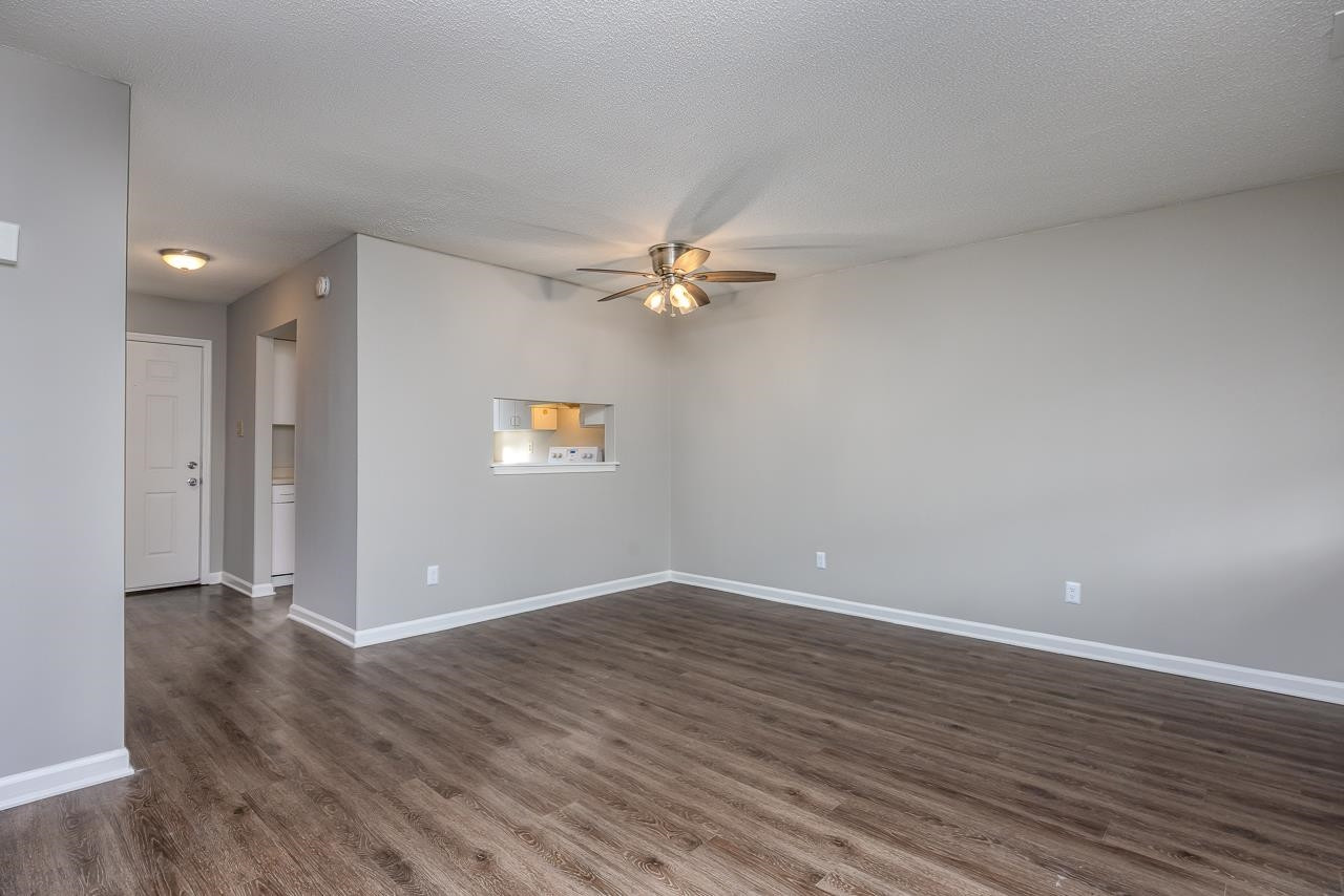 4265 Lake Ridge Drive, Unit 7C Raleigh, NC 27604 - Photo 10 of 19 a view of an empty room with wooden floor