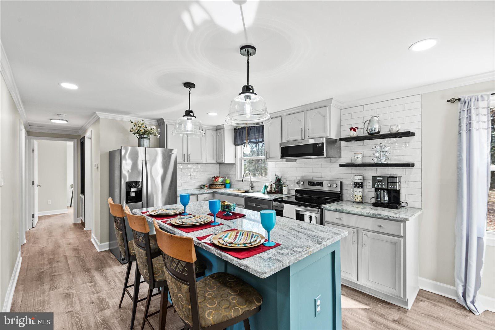 a kitchen that has a table and chairs in it