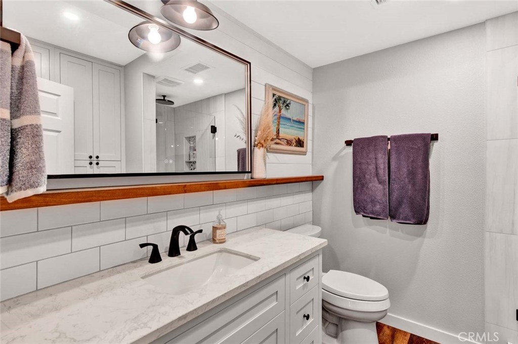 14762 Bridgeport Road Tustin, CA 92780 - Photo 16 of 29 a bathroom with a sink a toilet and mirror