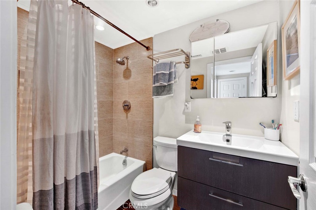 14762 Bridgeport Road Tustin, CA 92780 - Photo 19 of 29 a bathroom with a sink a toilet and shower curtain