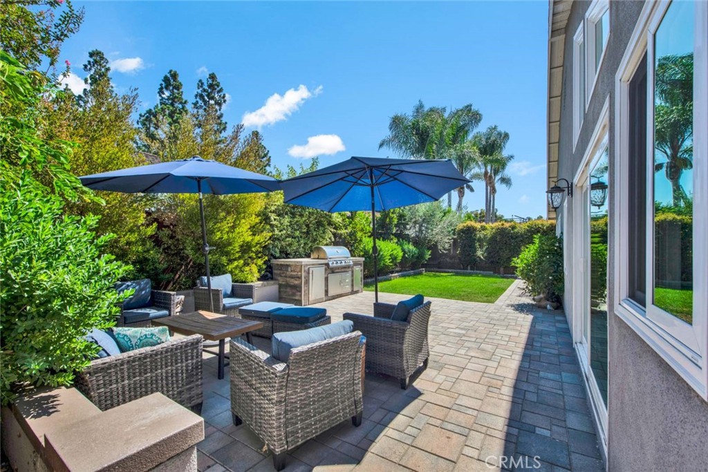 14762 Bridgeport Road Tustin, CA 92780 - Photo 21 of 29 a view of a patio with couches under an umbrella