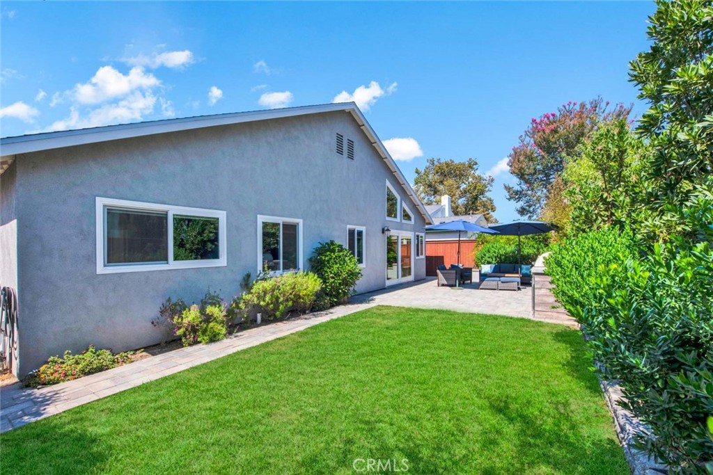 14762 Bridgeport Road Tustin, CA 92780 - Photo 24 of 29 a front view of a house with garden and sitting area