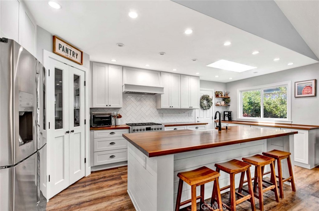 14762 Bridgeport Road Tustin, CA 92780 - Photo 6 of 29 a kitchen with stainless steel appliances a sink stove and refrigerator