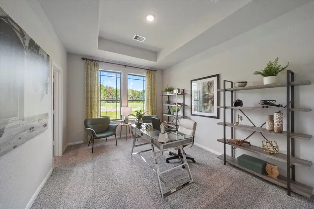 a living room with furniture a flat screen tv and a floor to ceiling window