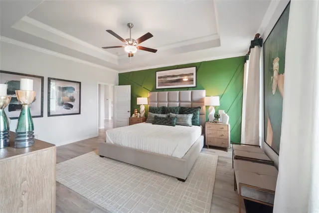 a bedroom with a large bed and a chandelier