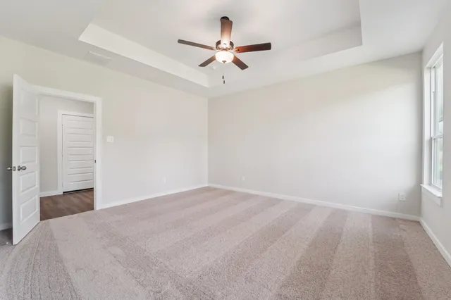 a view of a room with a ceiling fan