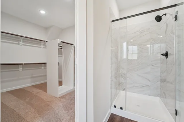 a bathroom with a glass shower door